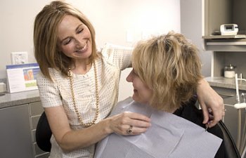 A Dentist getting ready a woman patient for a dental checkup