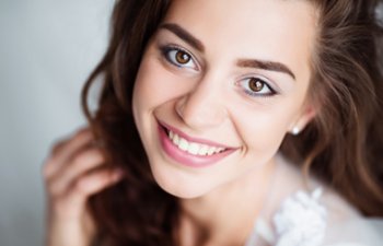 Woman showing perfect teeth with Porcelain Veneers in her smile