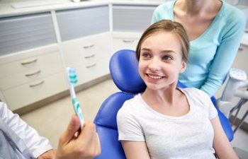Alpharetta GA Dentist educating a pediatric patient about oral health in Crabapple