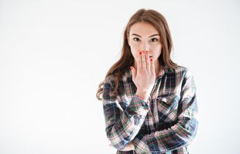 Young Woman Covering Mouth due to Cracked Tooth Alpharetta, GA