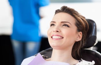 Woman in Dentist Smiling After Full Mouth Reconstruction Alpharetta GA