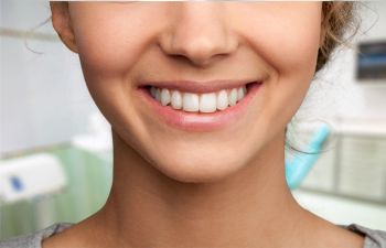 Smiling young woman after Cosmetic Dentistry Treatments in Alpharetta GA