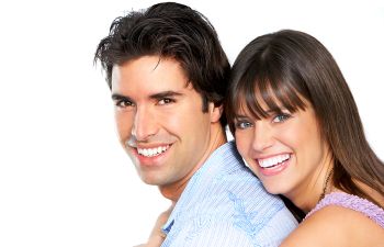 Cheerful couple showing their perfect white teeth in their smiles.